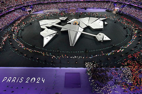 Flag bearers surround the stage during the 2024 Summer Olympics closing ceremony 